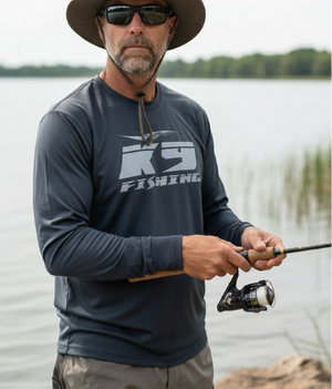 Angler wearing K9 Fishing navy long sleeve performance tee fishing at the lake