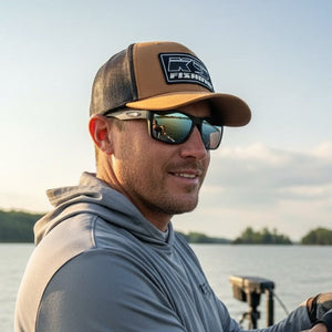 Angler wearing K9 Fishing brown rope hat with black patch logo on a boat